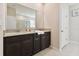 Elegant bathroom with double vanity, granite countertop, dark cabinets, and large mirror at 1409 Tropical Oasis Ave, Plant City, FL 33565