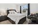 Comfortable bedroom featuring a storage bed, decorative curtains, a desk and a view of a neighboring home at 1409 Tropical Oasis Ave, Plant City, FL 33565