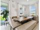Cozy dining area with a built-in banquette, bench seating and large windows offering serene outdoor views at 1409 Tropical Oasis Ave, Plant City, FL 33565