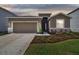Charming single-Gathering home featuring a well-manicured lawn and a two-car garage at 1409 Tropical Oasis Ave, Plant City, FL 33565