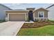 Charming single-Gathering home featuring a well-manicured lawn and a two-car garage at 1409 Tropical Oasis Ave, Plant City, FL 33565