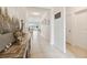 Inviting hallway with neutral tile flooring leading to a living space, offering a bright and airy feel at 1409 Tropical Oasis Ave, Plant City, FL 33565