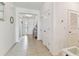 Bright hallway featuring neutral tile, white walls and trim, and well-lit entryway at 1409 Tropical Oasis Ave, Plant City, FL 33565