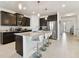 Stylish kitchen with stainless steel appliances, granite countertops, a center island and seating for three at 1409 Tropical Oasis Ave, Plant City, FL 33565