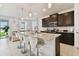 Modern kitchen featuring a granite island with seating and stainless steel appliances at 1409 Tropical Oasis Ave, Plant City, FL 33565