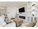 Cozy living room with fireplace, built-in shelves, and white couches at 1409 Tropical Oasis Ave, Plant City, FL 33565