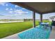 Relaxing covered patio with outdoor dining and serene lake views at 1409 Tropical Oasis Ave, Plant City, FL 33565