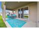 Covered patio with sliding glass doors and a view of the lake and backyard at 1409 Tropical Oasis Ave, Plant City, FL 33565