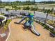Community playground featuring slides, climbing structures, and a shaded picnic area for outdoor fun at 1409 Tropical Oasis Ave, Plant City, FL 33565