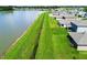 Aerial view of a waterfront property and large green space between homes and lake at 1409 Tropical Oasis Ave, Plant City, FL 33565