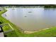Aerial view of the pond in the community with lush green shoreline at 1409 Tropical Oasis Ave, Plant City, FL 33565