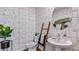 Modern bathroom with unique wallpaper, round mirror, and stylish fixtures at 17007 Barnwood Pl, Lakewood Ranch, FL 34211