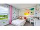 room featuring a single bed, a rainbow pillow, colorful polka dots, and a bright colored balloon picture frame at 17007 Barnwood Pl, Lakewood Ranch, FL 34211