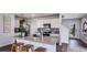Well-lit kitchen featuring a modern island, white cabinets, stainless steel appliances, and wood-look flooring at 17007 Barnwood Pl, Lakewood Ranch, FL 34211