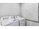 Bright laundry room with a modern washer and dryer and wall decorations at 17007 Barnwood Pl, Lakewood Ranch, FL 34211