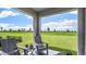 Relaxing covered patio with comfortable seating and stunning views of the expansive green lawn at 17007 Barnwood Pl, Lakewood Ranch, FL 34211