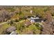 Overhead view of the houses revealing a backyard pool, complemented by mature trees and a green lawn at 17119 Rainbow Ter, Odessa, FL 33556