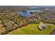 Wide shot of the property highlighted with a pin, with lake views and verdant surroundings in the background at 17119 Rainbow Ter, Odessa, FL 33556