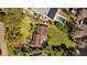 Aerial view showcasing the neighborhood houses, green lawns, and an inground swimming pool with lots of privacy at 17119 Rainbow Ter, Odessa, FL 33556