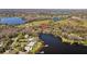 Stunning aerial view of a waterfront property, showcasing the home's proximity to the lake and surrounding landscape at 17119 Rainbow Ter, Odessa, FL 33556