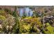 Stunning aerial view of the lakefront property with lush landscaping and private dock, perfect for lakeside living at 17119 Rainbow Ter, Odessa, FL 33556