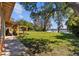 Spacious backyard featuring a lush lawn, mature trees, and serene lake views, creating a perfect outdoor retreat at 17119 Rainbow Ter, Odessa, FL 33556