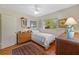 This bedroom features a window view, a bed, ceiling fan, and 2 wooden chests at 17119 Rainbow Ter, Odessa, FL 33556