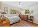 This bedroom features a window view, a bed, ceiling fan, and 2 wooden chests at 17119 Rainbow Ter, Odessa, FL 33556