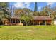Charming single-story home with a spacious backyard, a screened in lanai, and a cozy covered patio area at 17119 Rainbow Ter, Odessa, FL 33556