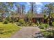 Inviting home featuring a walkway leading to the front door, surrounded by verdant landscaping and greenery at 17119 Rainbow Ter, Odessa, FL 33556