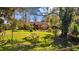 Charming single-story home surrounded by a beautifully landscaped front yard with lush greenery and mature trees at 17119 Rainbow Ter, Odessa, FL 33556