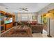 Cozy living room with comfortable seating, built-in shelving, and a large window with sheer curtains at 17119 Rainbow Ter, Odessa, FL 33556
