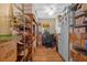 An office hallway surrounded by cabinets and wire racks containing boxes and other items at 17119 Rainbow Ter, Odessa, FL 33556