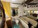 An eclectic bathroom with a jacuzzi tub, yellow curtain, and dark wood vanity at 17233 Dalberg Dr, Spring Hill, FL 34610