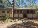 A single story home with a lattice porch in front and a natural woodsy landscape at 17233 Dalberg Dr, Spring Hill, FL 34610