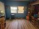 This interior space offers wood-look floors, bright blue walls and multiple windows for natural light at 17233 Dalberg Dr, Spring Hill, FL 34610