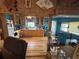 A farmhouse style kitchen with wood floors and cabinetry, blue walls, and an open concept at 17233 Dalberg Dr, Spring Hill, FL 34610