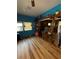 Spacious open living room, hardwood floors, blue walls, and open to the kitchen at 17233 Dalberg Dr, Spring Hill, FL 34610