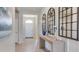 Inviting hallway featuring elegant mirrors, console table, and neutral tones creating a warm ambiance at 17723 Pastureland Ave, Lakewood Ranch, FL 34211