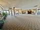 Expansive lobby with elegant chandelier, columns, and neutral carpet at 2333 Feather Sound Dr # C708, Clearwater, FL 33762