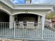 Outdoor kitchen and seating area with countertop, chairs, and overhead shelter at 2333 Feather Sound Dr # C708, Clearwater, FL 33762