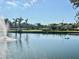 Scenic pond view with fountain, palm trees, and verdant landscape at 2333 Feather Sound Dr # C708, Clearwater, FL 33762