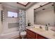 Cozy bathroom featuring a shower-tub combo and ample vanity space at 2343 Wilshire Dr, Dunedin, FL 34698