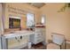 Bathroom featuring a single sink vanity, toilet, and a decoratively painted wall at 2343 Wilshire Dr, Dunedin, FL 34698