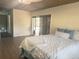 Bright bedroom with a woven ceiling, sliding glass doors, and a cozy bed with white bedding at 2343 Wilshire Dr, Dunedin, FL 34698