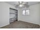 Bedroom features a ceiling fan, built-in closet shelving, and neutral carpet at 2343 Wilshire Dr, Dunedin, FL 34698