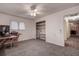Bedroom with neutral carpet, a ceiling fan, a window, and a closet with shelves at 2343 Wilshire Dr, Dunedin, FL 34698