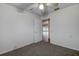 Bedroom with neutral carpet features a ceiling fan and an open doorway at 2343 Wilshire Dr, Dunedin, FL 34698