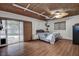 Bedroom with wood floor, unique ceiling, a ceiling fan, and a sliding glass door at 2343 Wilshire Dr, Dunedin, FL 34698