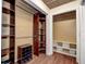 Spacious walk-in closet with custom shelving and wood-look flooring at 2343 Wilshire Dr, Dunedin, FL 34698